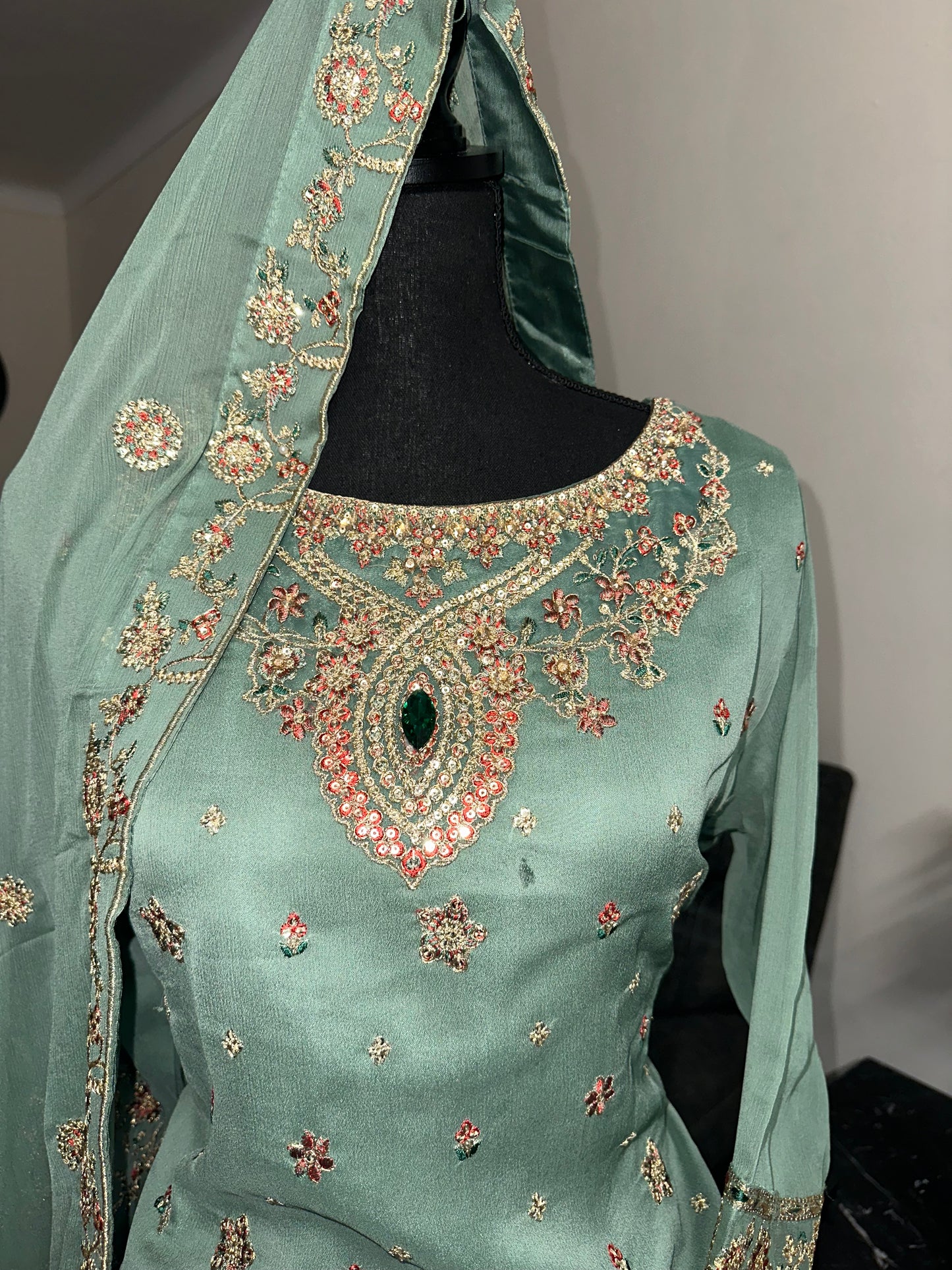 Green shrara set with gold embroidery work.