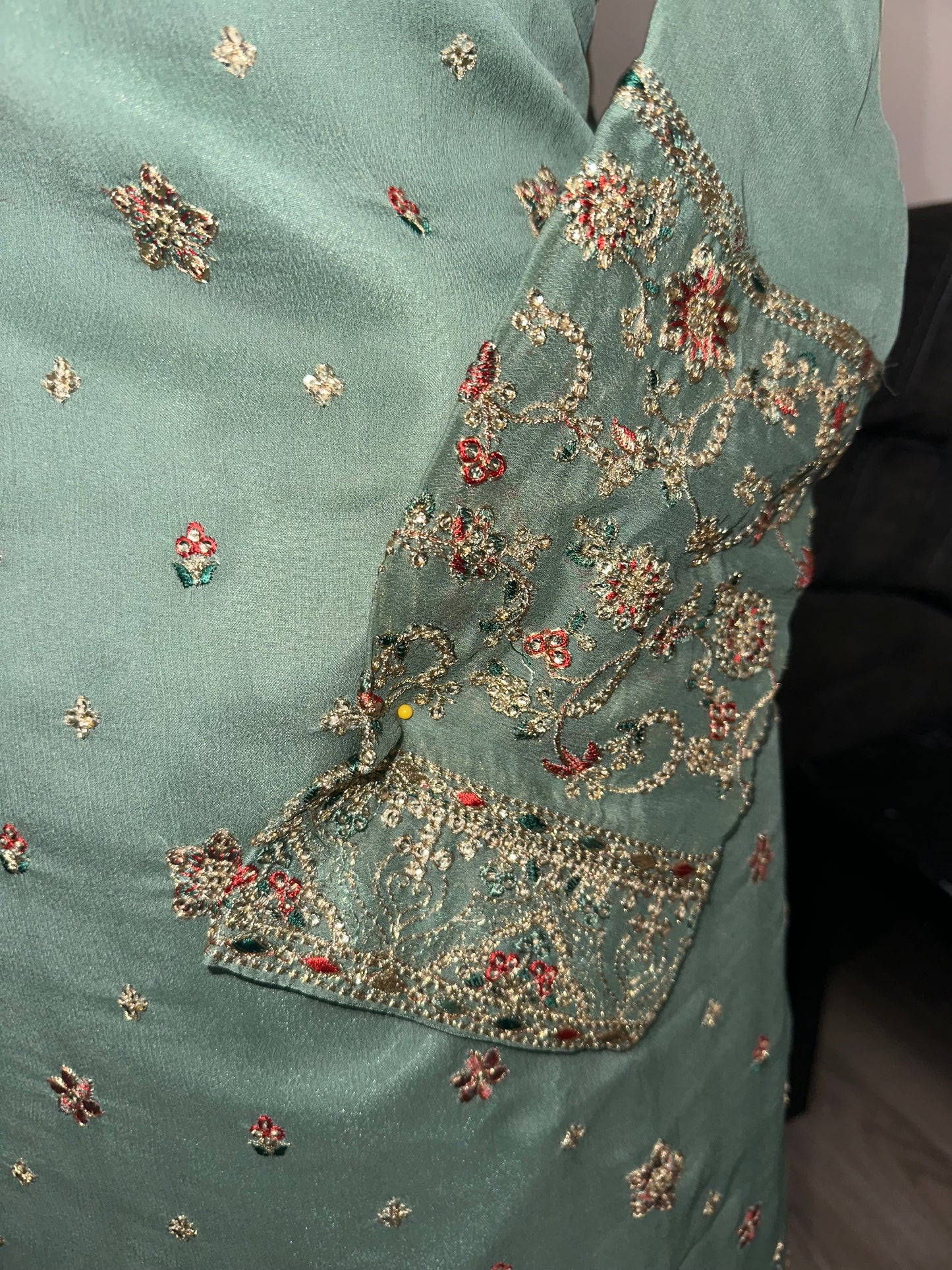 Green shrara set with gold embroidery work.