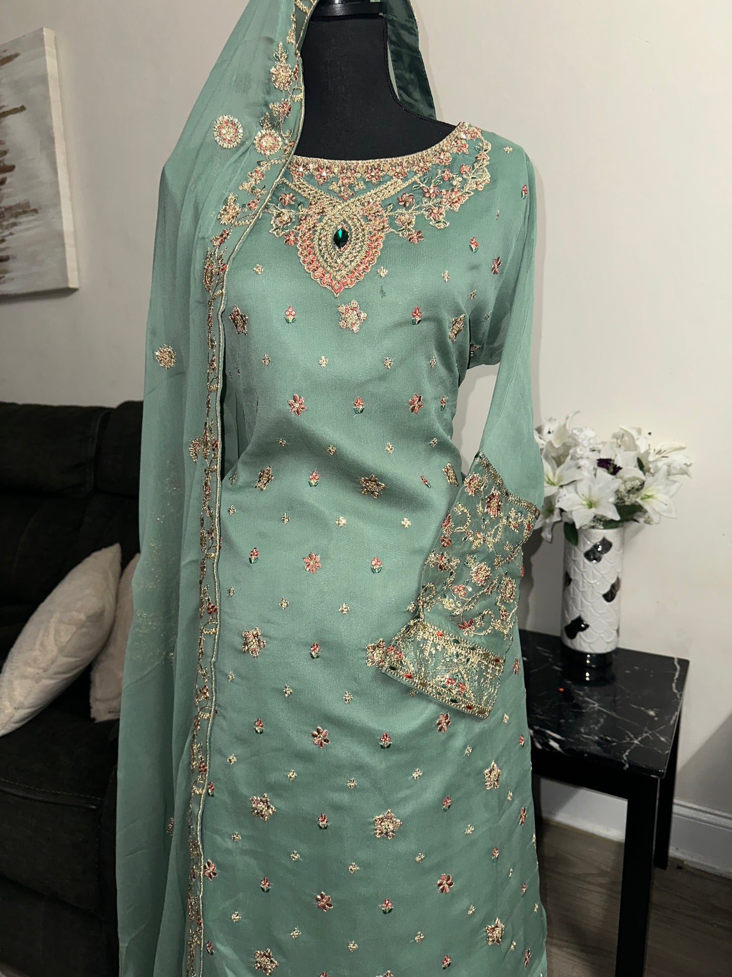 Green shrara set with gold embroidery work.
