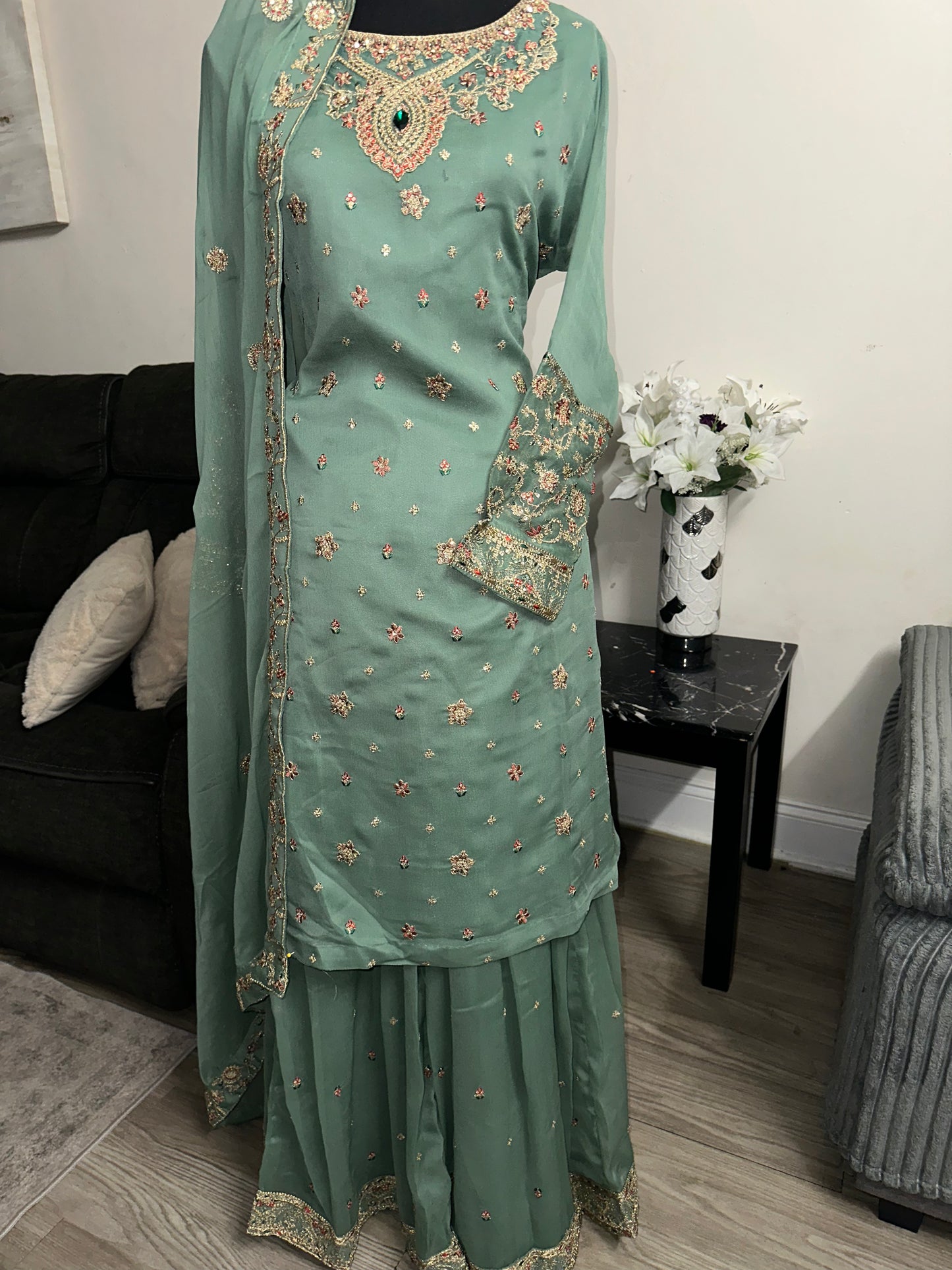 Green shrara set with gold embroidery work.