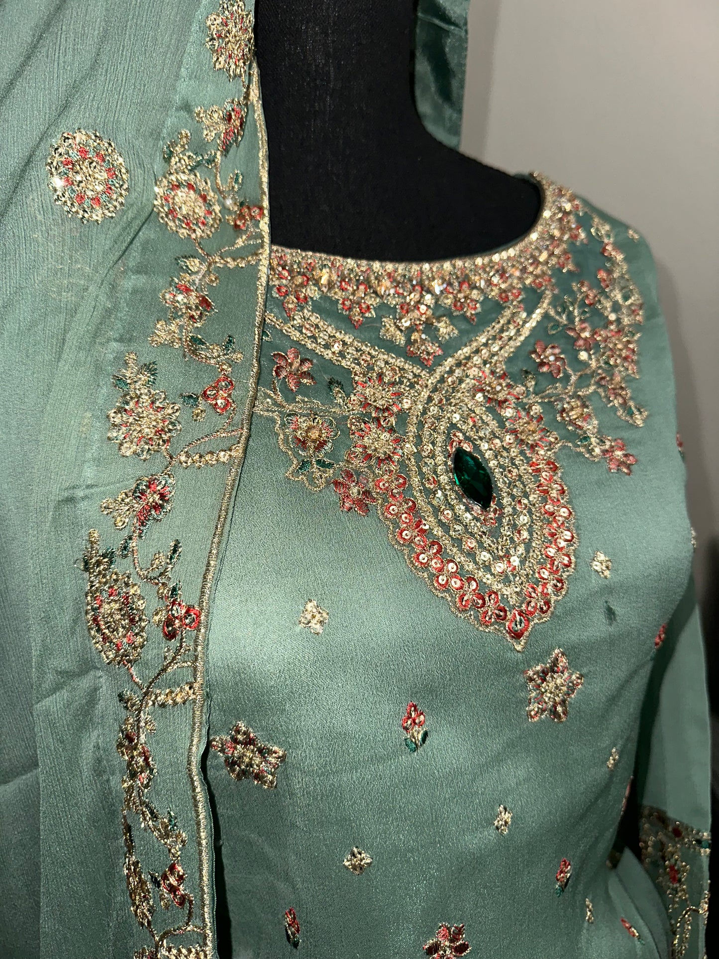 Green shrara set with gold embroidery work.